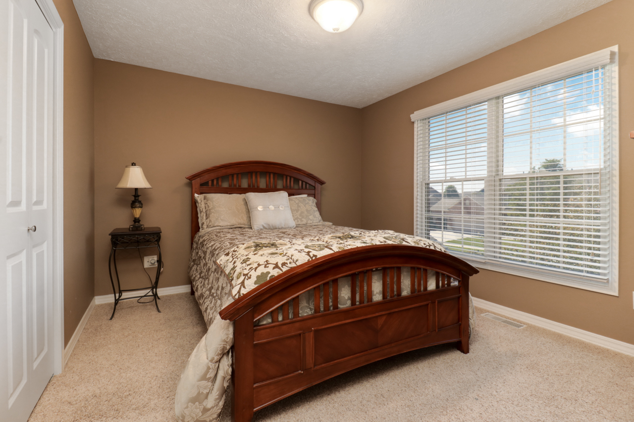 4012 Rockledge Road Bloomington, IL 61705 - Photo 35 of 63 a bed sitting in a bedroom next to a window