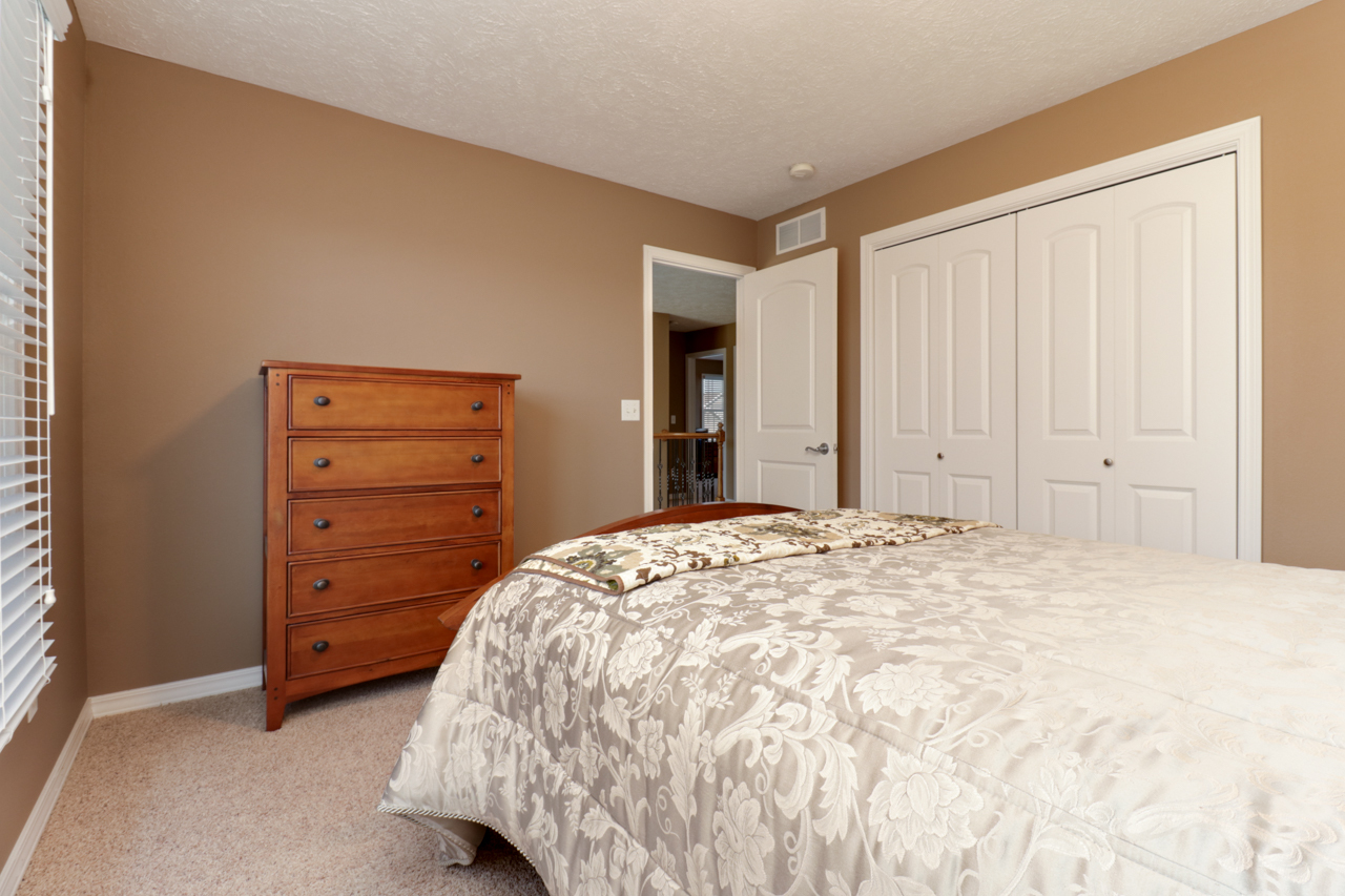 4012 Rockledge Road Bloomington, IL 61705 - Photo 36 of 63 a bedroom with a bed and a dresser