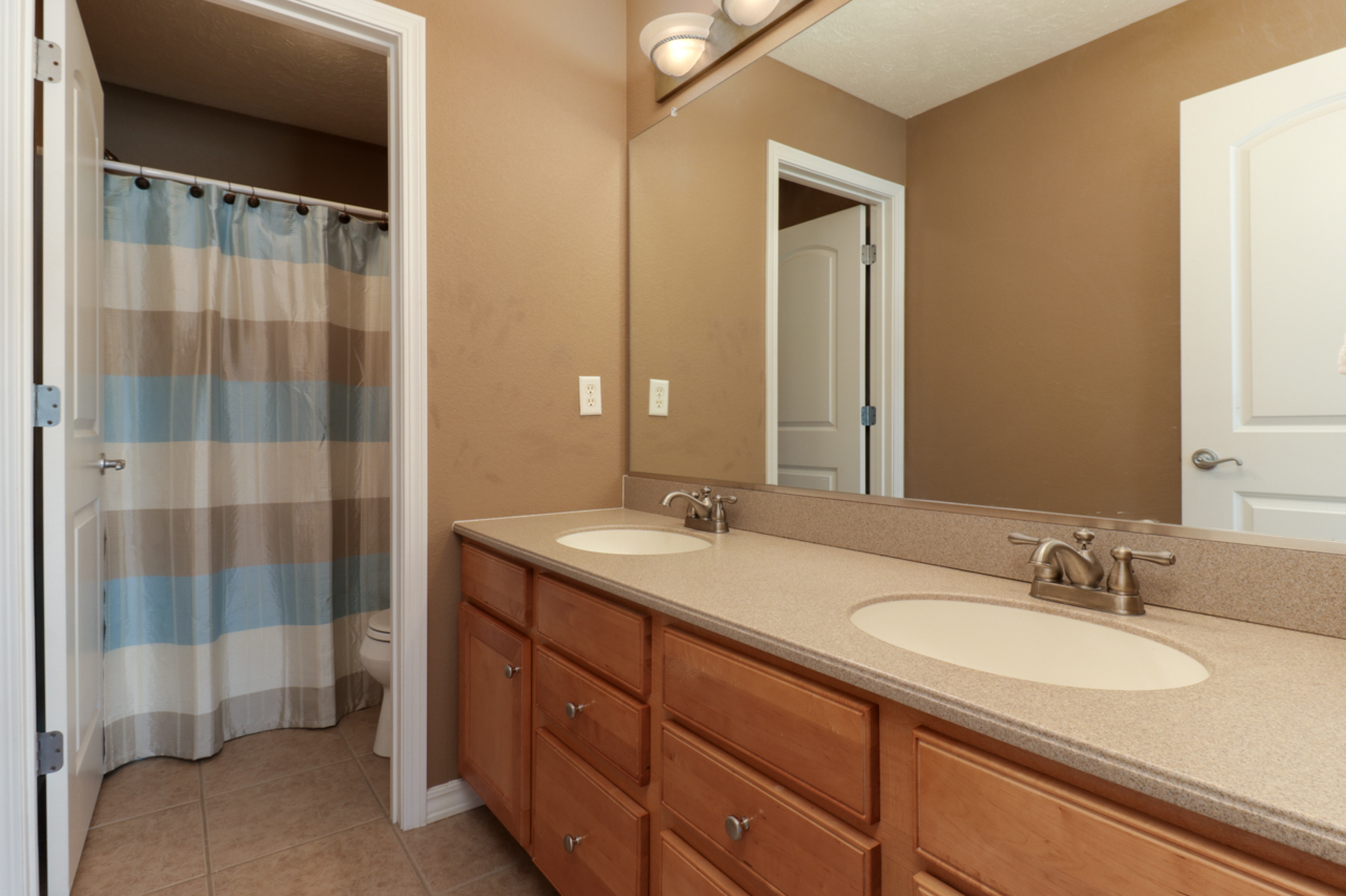 4012 Rockledge Road Bloomington, IL 61705 - Photo 37 of 63 a bathroom with a granite countertop sink and a mirror