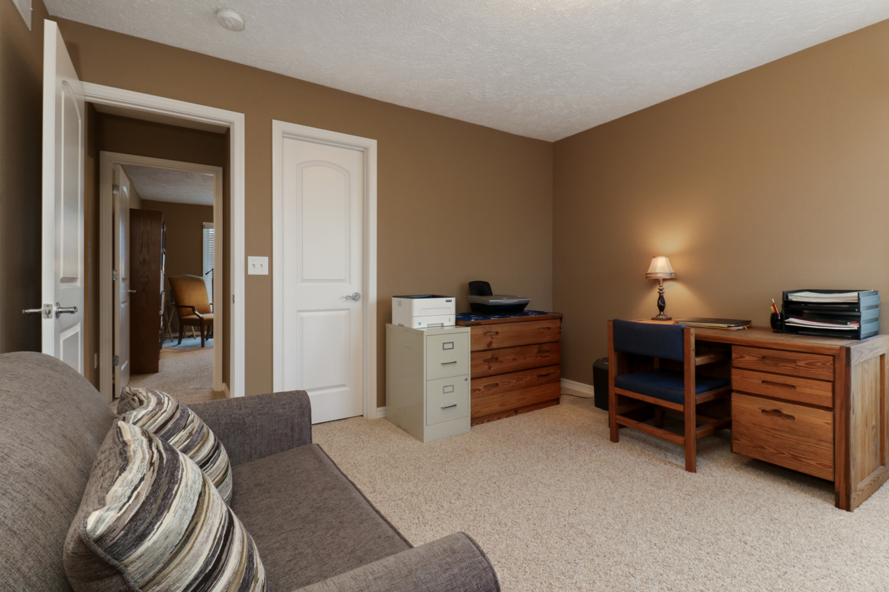 4012 Rockledge Road Bloomington, IL 61705 - Photo 39 of 63 a bedroom with a bed and a desk