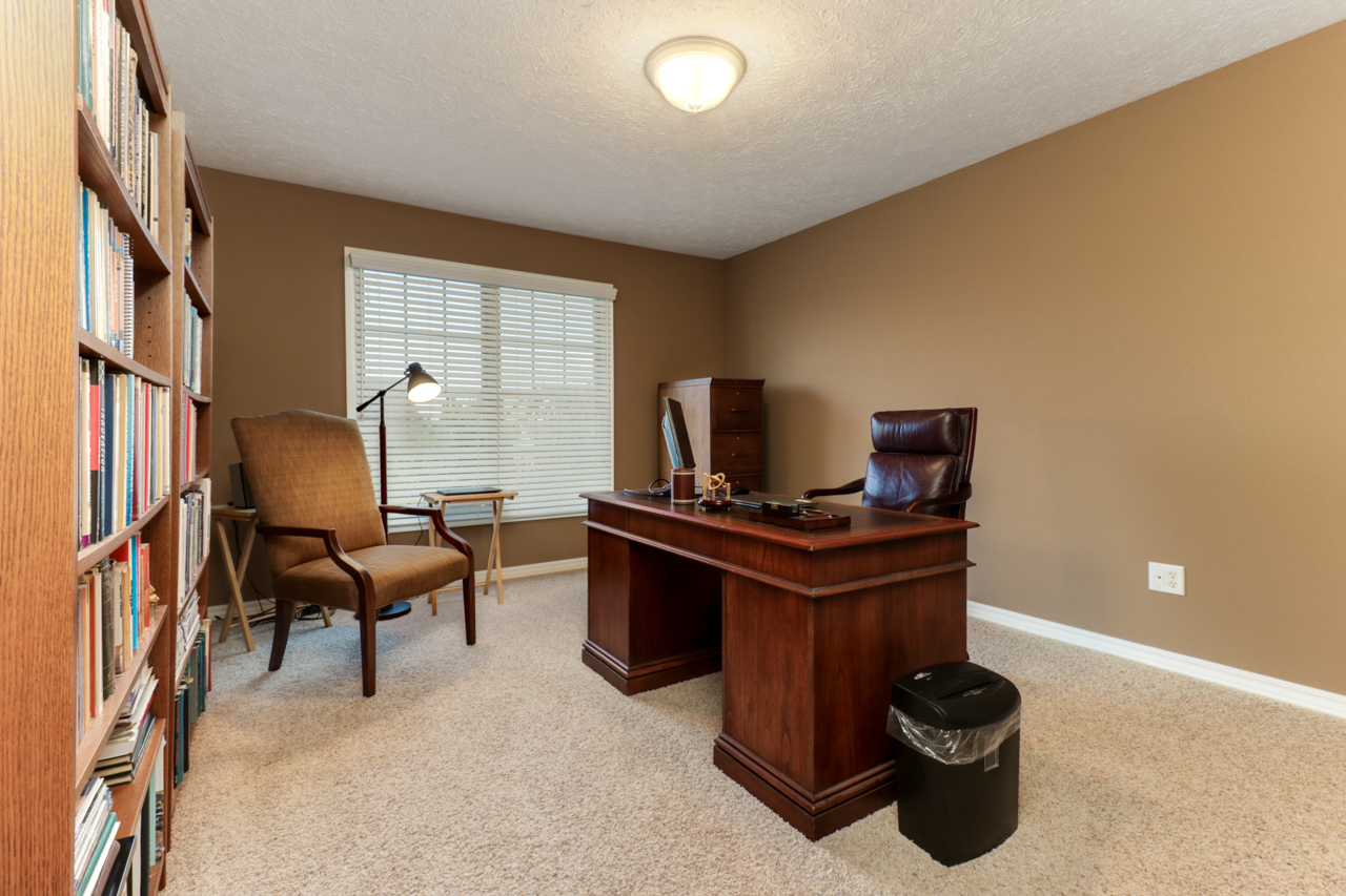 4012 Rockledge Road Bloomington, IL 61705 - Photo 40 of 63 a living room with furniture and a flat screen tv