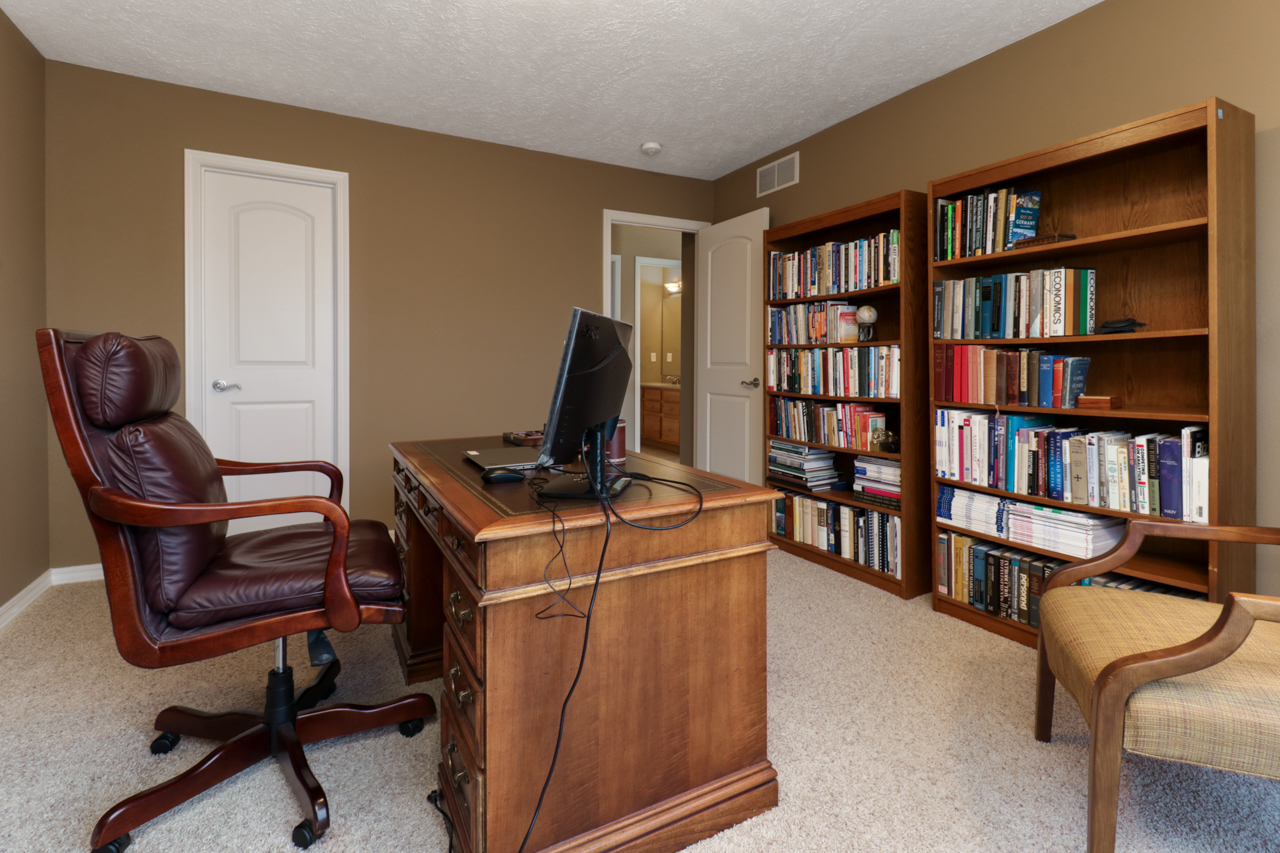 4012 Rockledge Road Bloomington, IL 61705 - Photo 41 of 63 a view of a workspace with furniture and a bookshelf