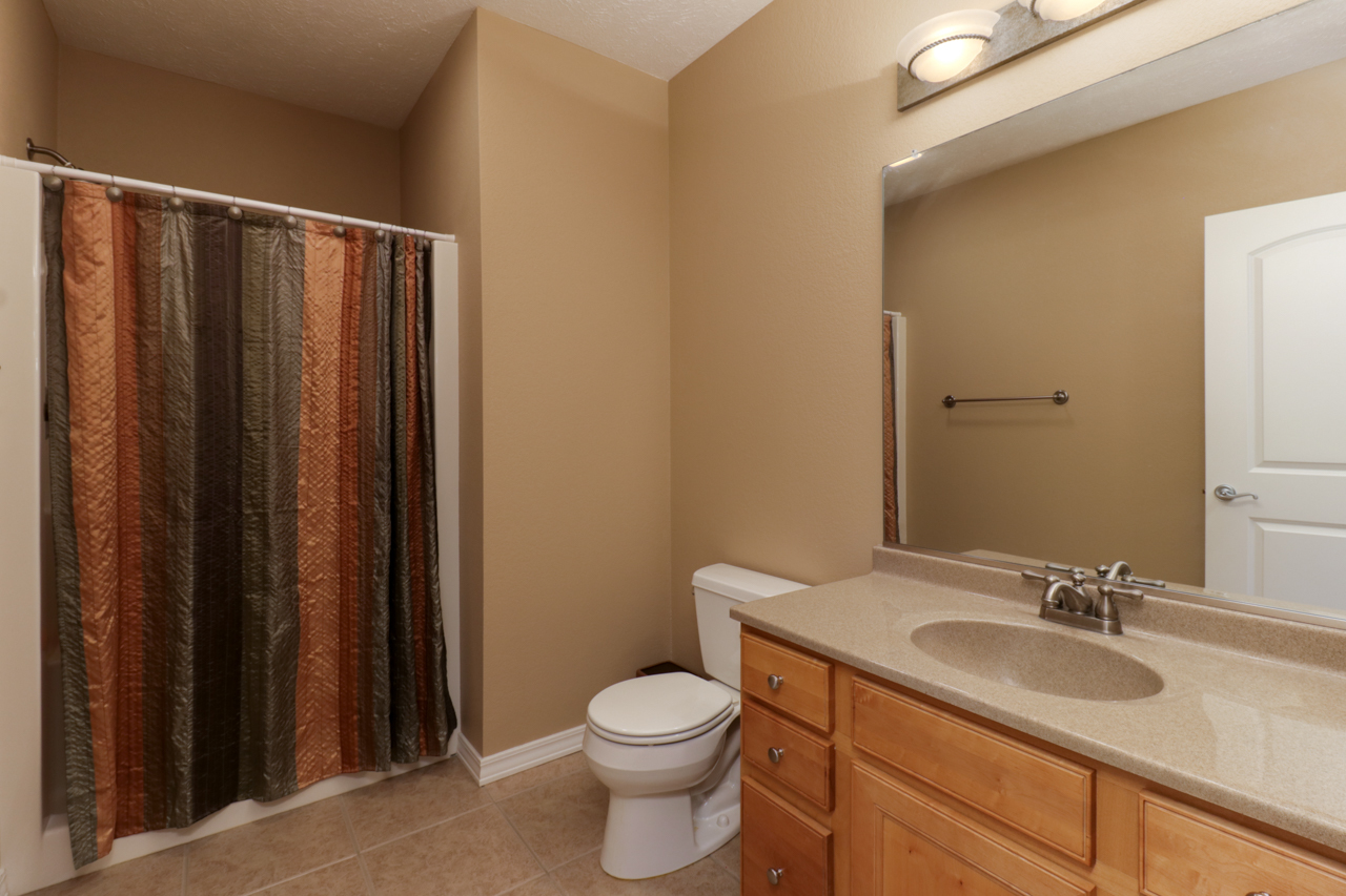 4012 Rockledge Road Bloomington, IL 61705 - Photo 44 of 63 a bathroom with a granite countertop sink toilet and a mirror