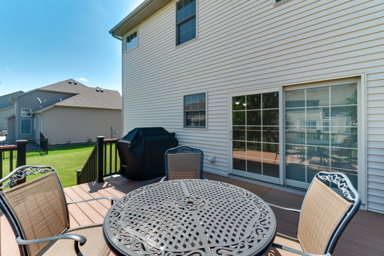 4012 Rockledge Road Bloomington, IL 61705 - Photo 49 of 63 a view of a deck with table and chairs with wooden floor and fence