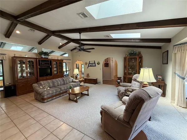 a spacious bedroom with a large bed and windows