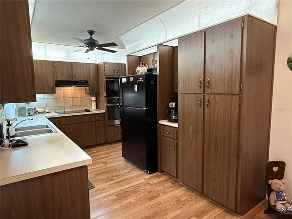 a spacious bedroom with a bed and a flat screen tv
