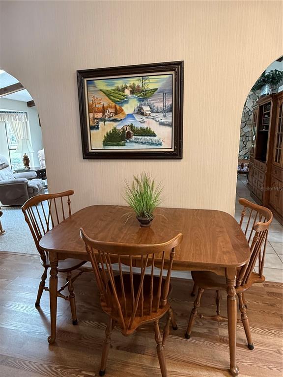 9901 Southwest 67th Terrace Ocala, FL 34476 - Photo 17 of 71 a view of a dining room with furniture window and wooden floor