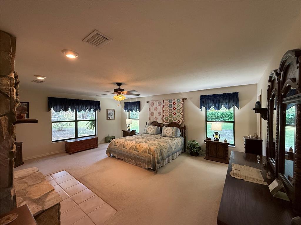9901 Southwest 67th Terrace Ocala, FL 34476 - Photo 20 of 71 a spacious bedroom with a large bed and windows