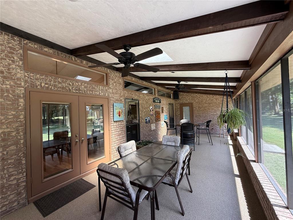9901 Southwest 67th Terrace Ocala, FL 34476 - Photo 34 of 71 a dining room with furniture wooden floor and a chandelier