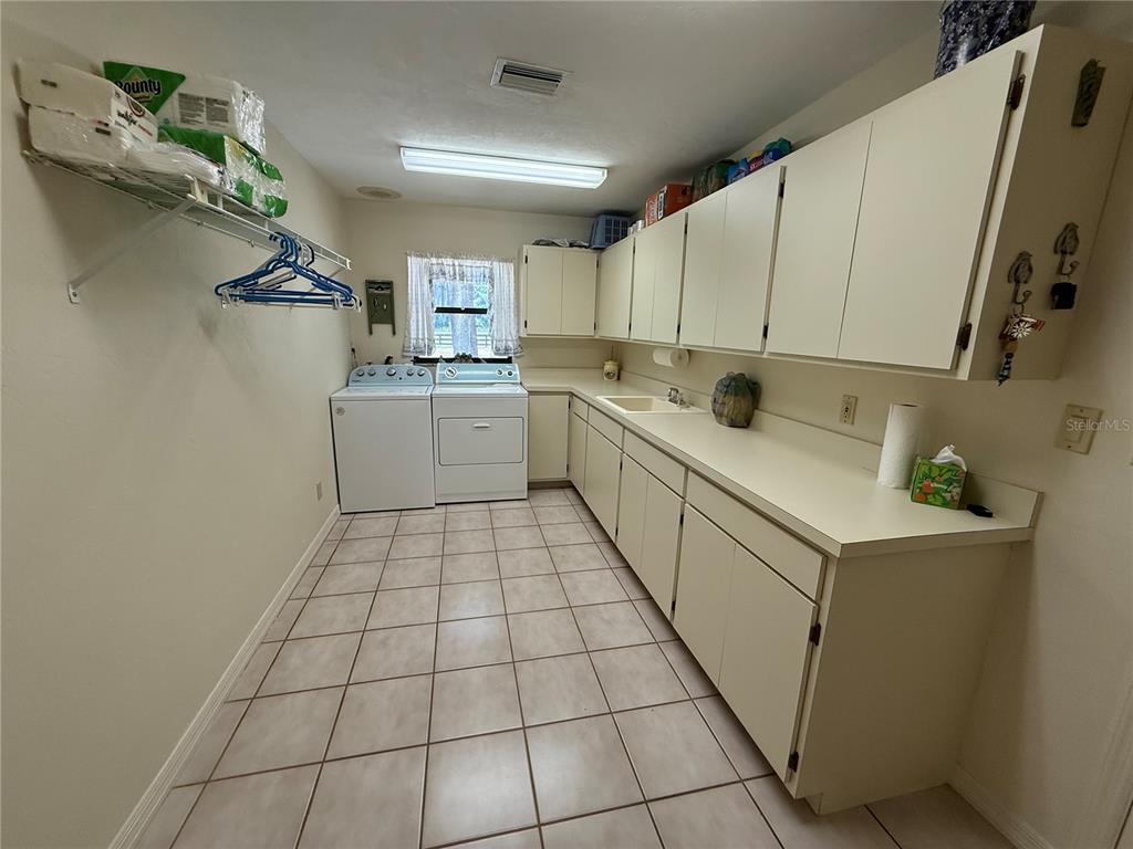 9901 Southwest 67th Terrace Ocala, FL 34476 - Photo 37 of 71 a kitchen with a sink a stove and cabinets