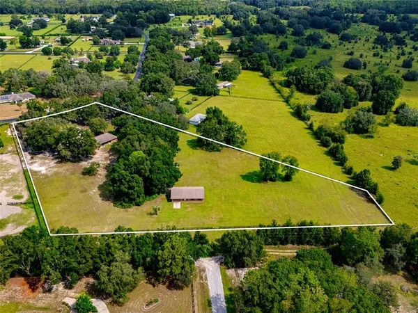 a view of a living room with furniture and chandelier
