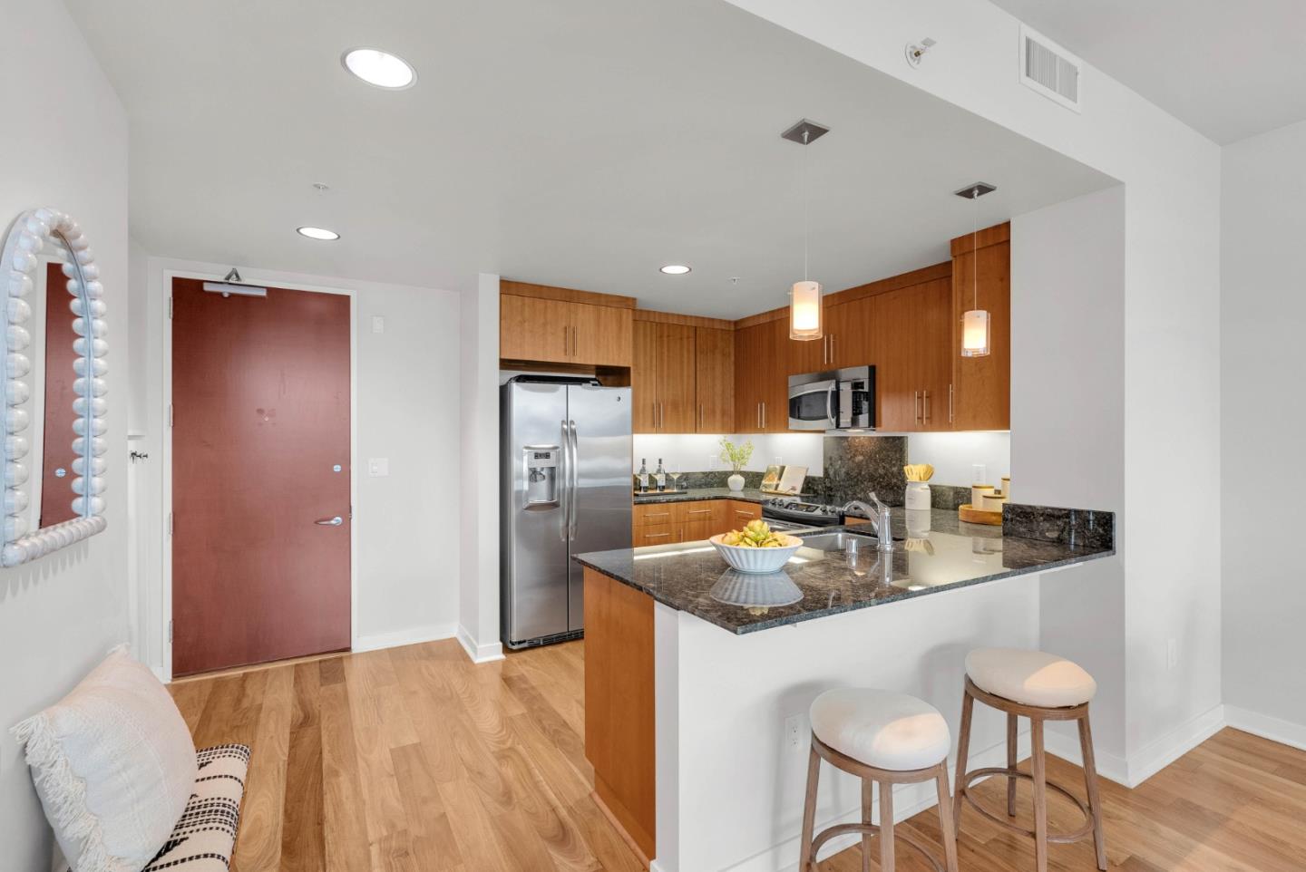 38 North Almaden Boulevard, Unit 1805 San Jose, CA 95110 - Photo 14 of 38 a kitchen with refrigerator and chairs