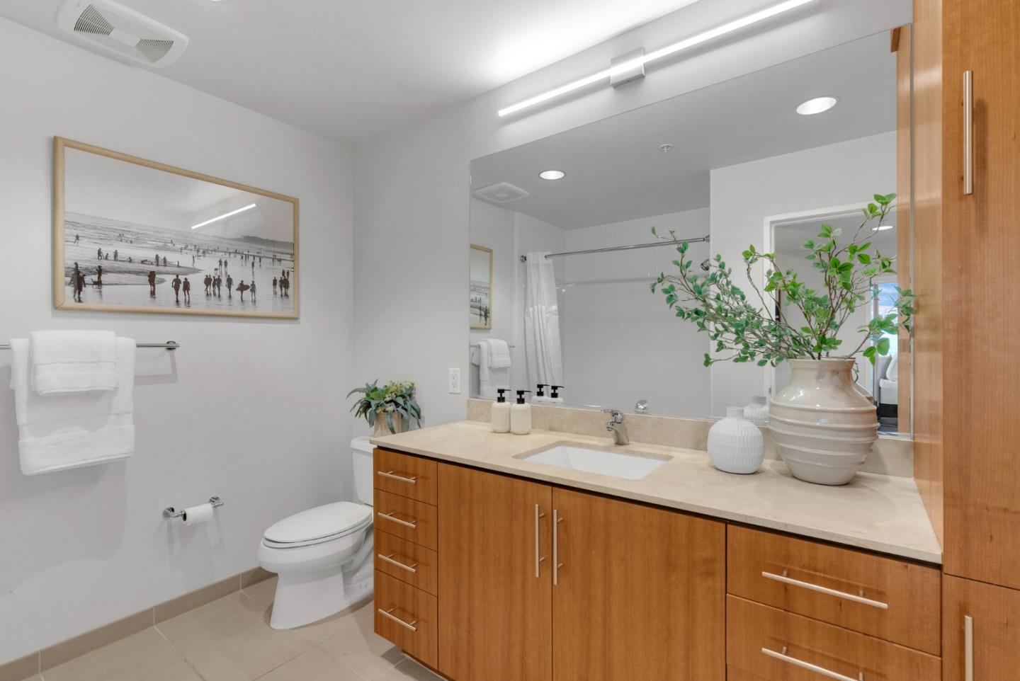 38 North Almaden Boulevard, Unit 1805 San Jose, CA 95110 - Photo 19 of 38 a bathroom with a granite countertop sink a toilet and a mirror