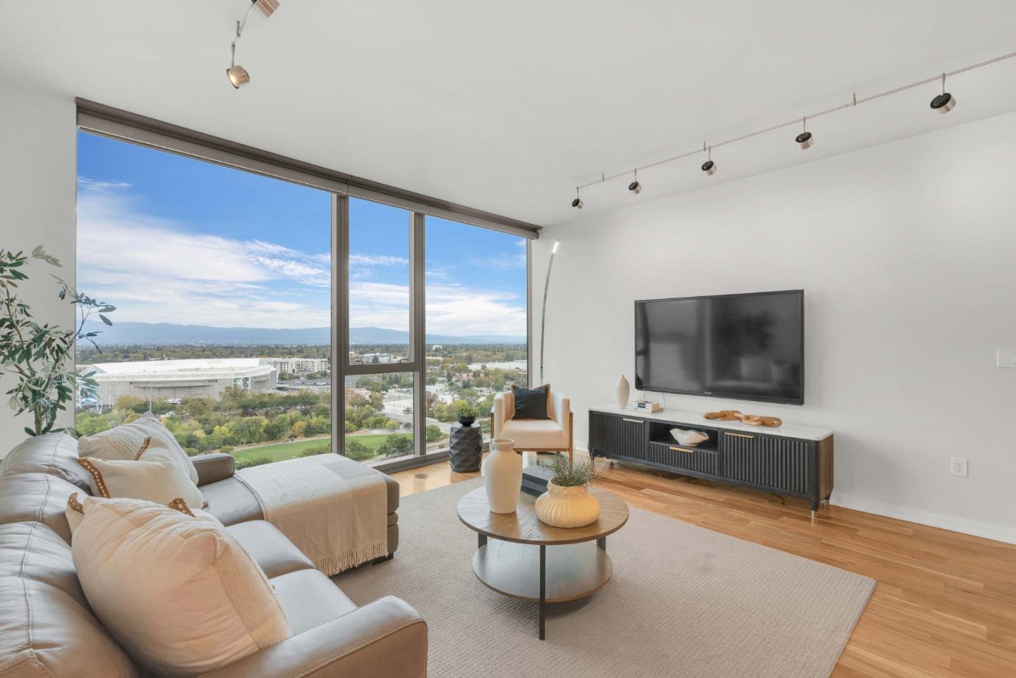 38 North Almaden Boulevard, Unit 1805 San Jose, CA 95110 - Photo 2 of 38 a living room with furniture and a flat screen tv