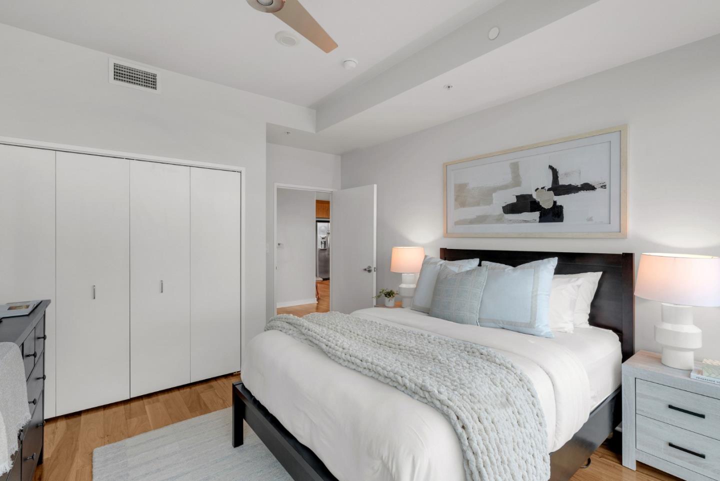 38 North Almaden Boulevard, Unit 1805 San Jose, CA 95110 - Photo 22 of 38 a bedroom with a bed and a painting on the wall