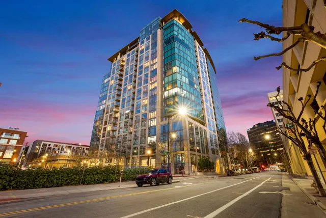 a view of a tall building next to a road