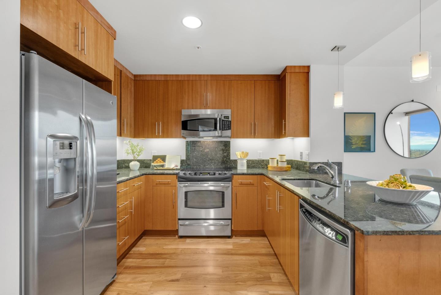 38 North Almaden Boulevard, Unit 1805 San Jose, CA 95110 - Photo 10 of 38 a kitchen with stainless steel appliances granite countertop a sink stove and refrigerator