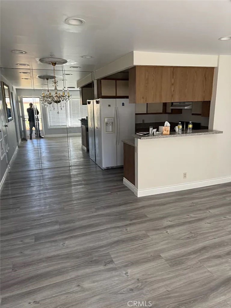 3880 West Jacinto View Road, Unit M Banning, CA 92220 - Photo 2 of 12 a view of a kitchen with wooden floor and a refrigerator