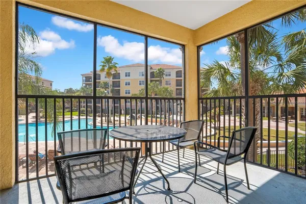 a view of a two chairs and table in the balcony