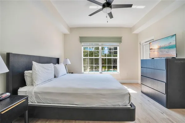 a large bed sitting in a bedroom next to a window