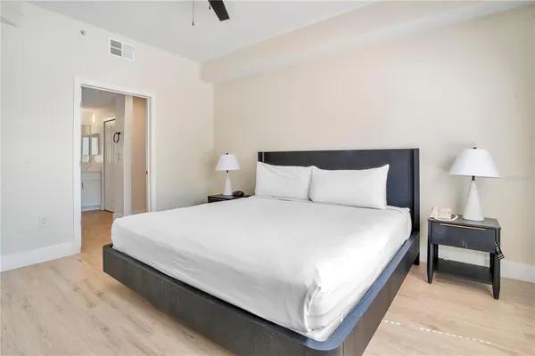 a bedroom with a bed and a night stand