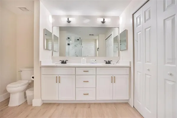 a bathroom with a sink a toilet and a mirror