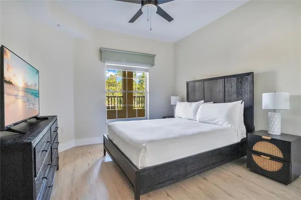 a bedroom with a bed and a flat screen tv