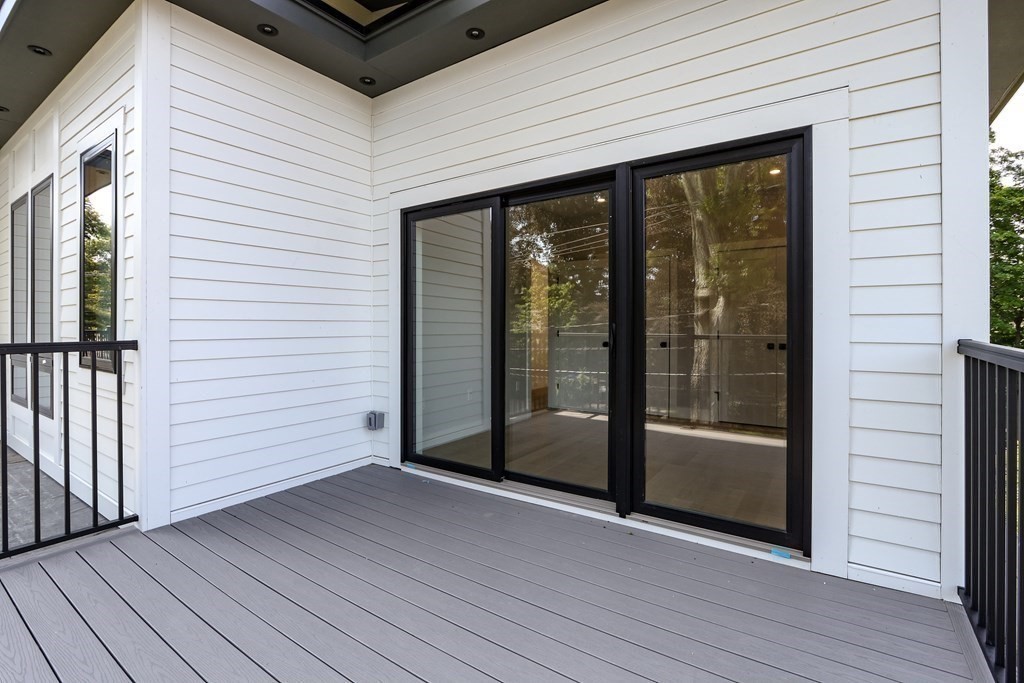 70 Washington Street, Unit 70 Newton, MA 02458 - Photo 17 of 25 a view of a terrace with wooden floor and floor to ceiling window