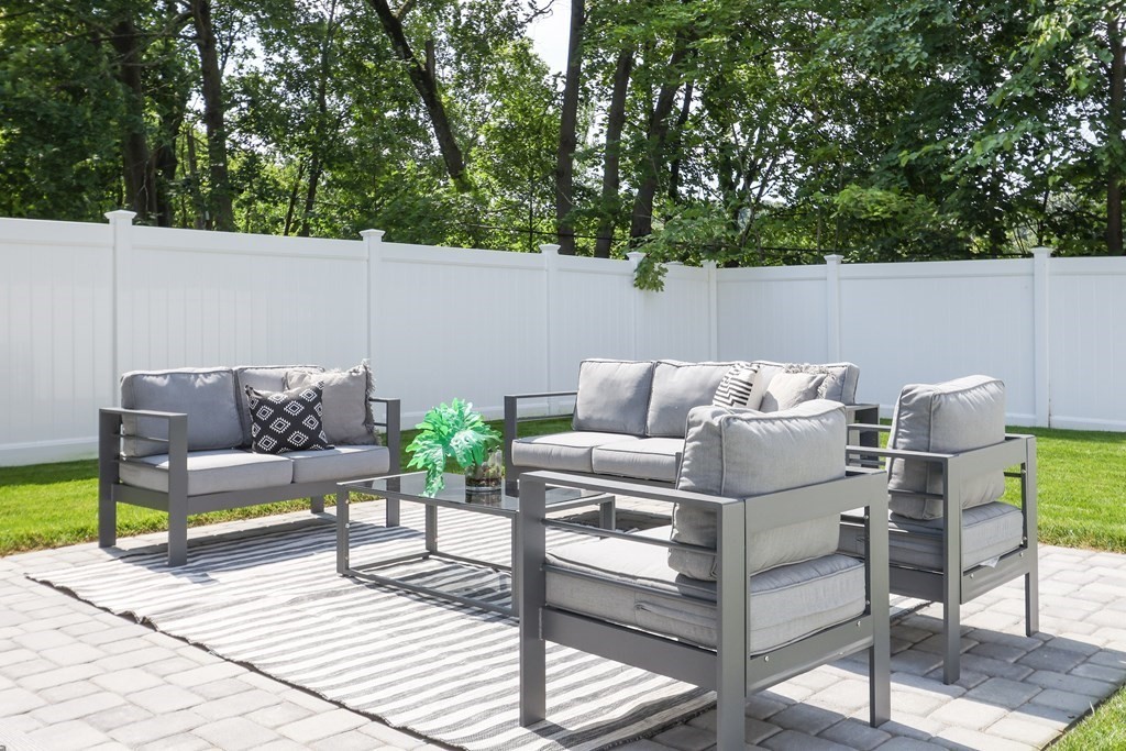 70 Washington Street, Unit 70 Newton, MA 02458 - Photo 23 of 25 a view of patio with couches and a table and chairs with wooden floor
