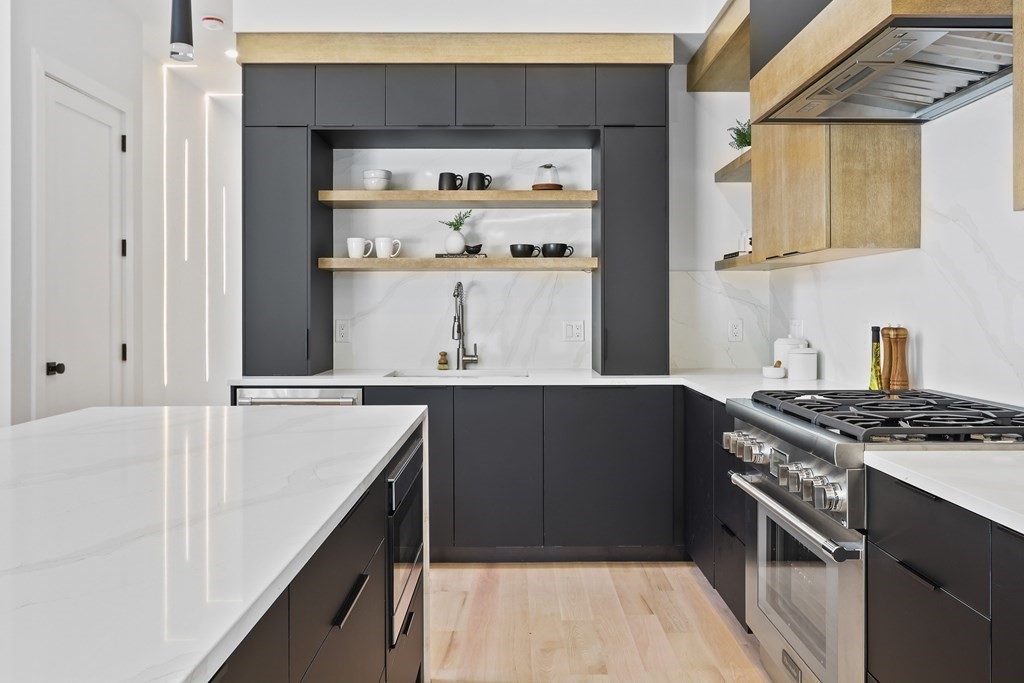 70 Washington Street, Unit 70 Newton, MA 02458 - Photo 3 of 25 a kitchen with stainless steel appliances a stove and a refrigerator