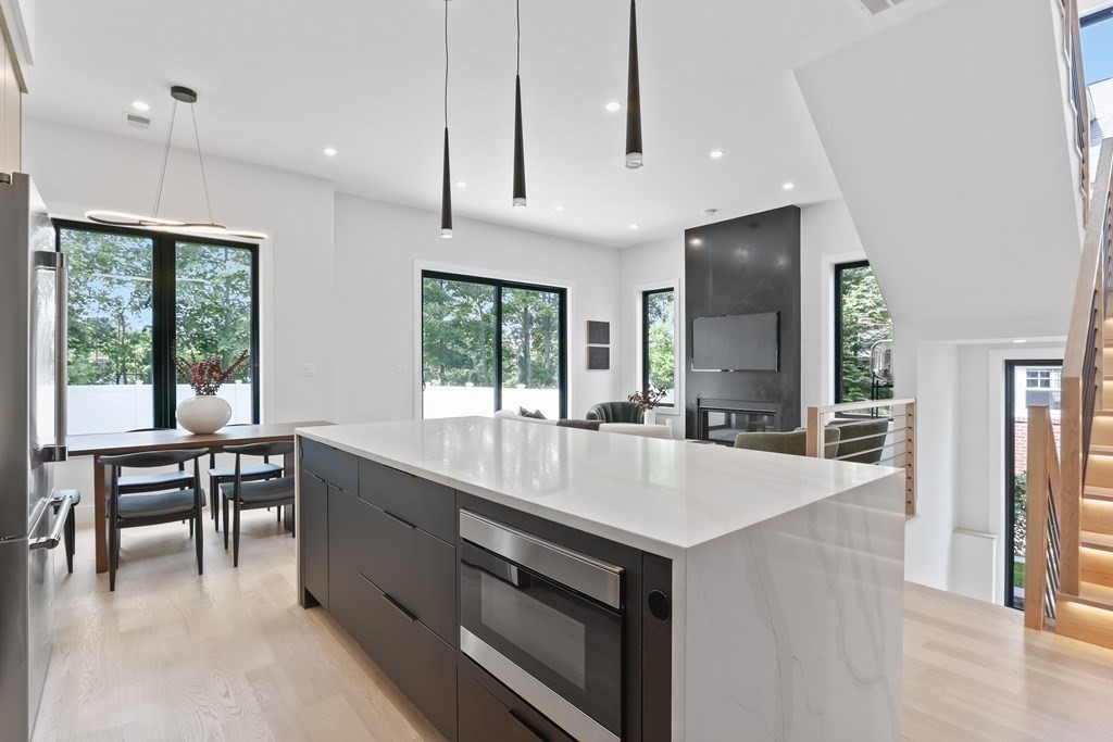 70 Washington Street, Unit 70 Newton, MA 02458 - Photo 8 of 25 a large kitchen with kitchen island a large island in it