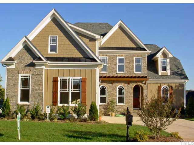 12408 Angel Road Raleigh, NC 27606 - Photo 1 of 12 front view of a house with a yard