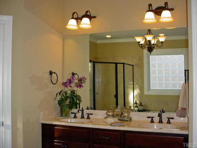12408 Angel Road Raleigh, NC 27606 - Photo 11 of 12 a bathroom with a sink and a mirror