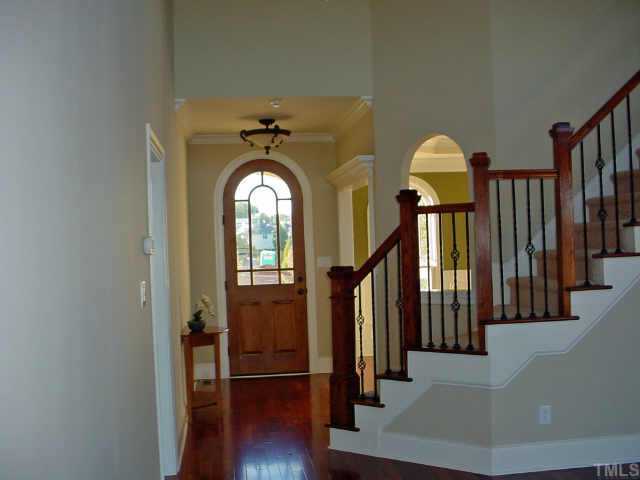 12408 Angel Road Raleigh, NC 27606 - Photo 3 of 12 a view of entryway with wooden floor and stairs