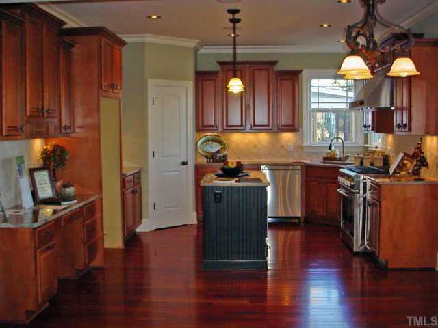 12408 Angel Road Raleigh, NC 27606 - Photo 7 of 12 a kitchen with granite countertop a stove a sink and a refrigerator