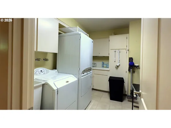 a utility room with cabinets and washer