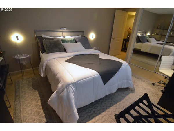 a bedroom with a bed and a night stand