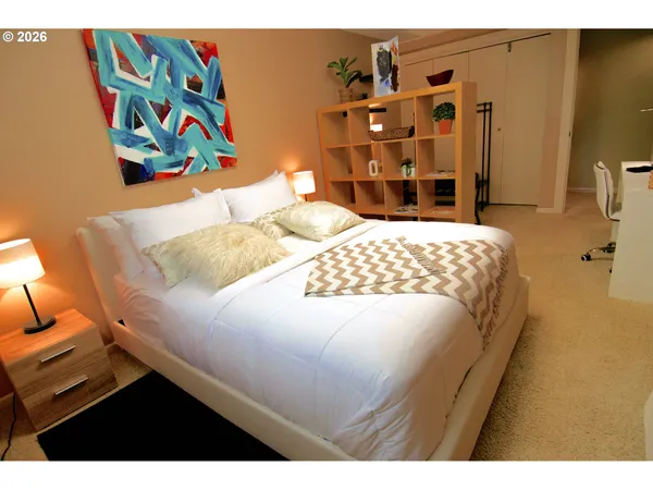 a bedroom with a bed and dresser