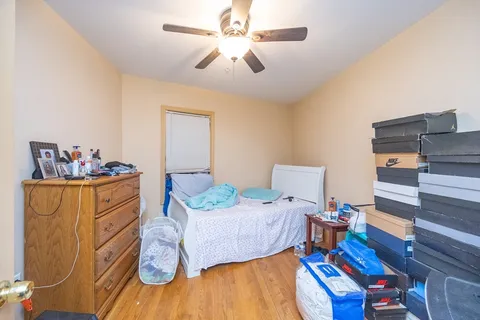 a bed room with a bed furniture and a wooden floor