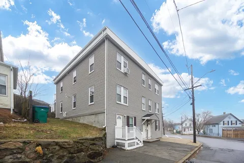 a front view of a residential apartment building with a yard