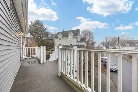 a view of a balcony with wooden fence