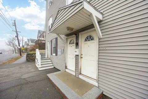 a view of front door and deck of the house