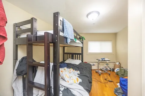 a view of gym equipment and wooden floor