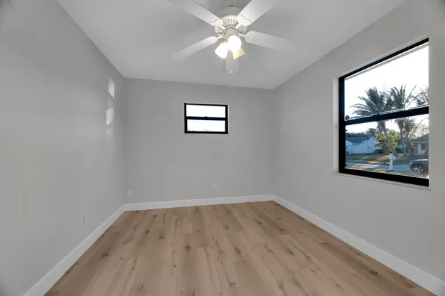 wooden floor in an empty room with a window