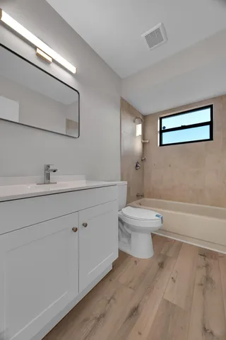 a bathroom with a toilet a sink and mirror