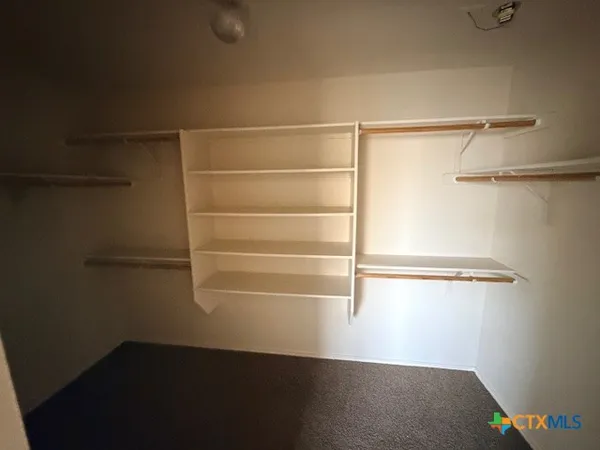 a view of a room with a window and a ceiling fan