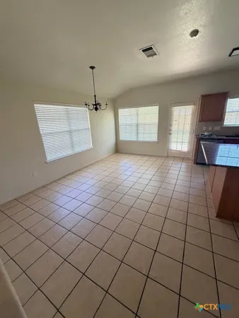 a kitchen with stainless steel appliances a refrigerator and a stove top oven