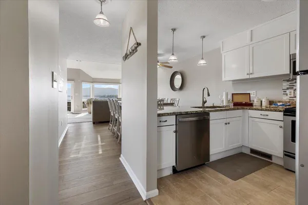 a living room with furniture large window and a fireplace