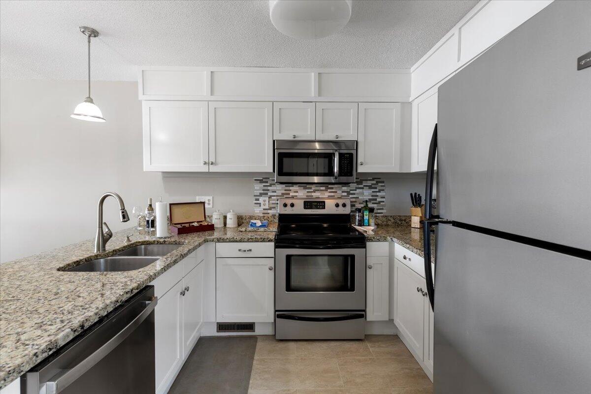 1206 Nature Lane Union Hall, VA 24176 - Photo 18 of 106 a kitchen with granite countertop a sink stove and refrigerator