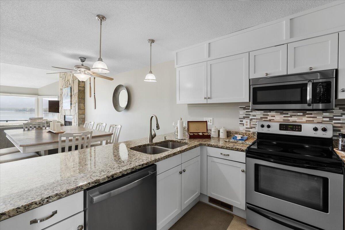 1206 Nature Lane Union Hall, VA 24176 - Photo 19 of 106 a kitchen with granite countertop a sink stainless steel appliances and white cabinets